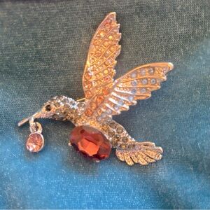 NWOT Hummingbird brooch with purple and silver ab Rhinestones on silver frame.